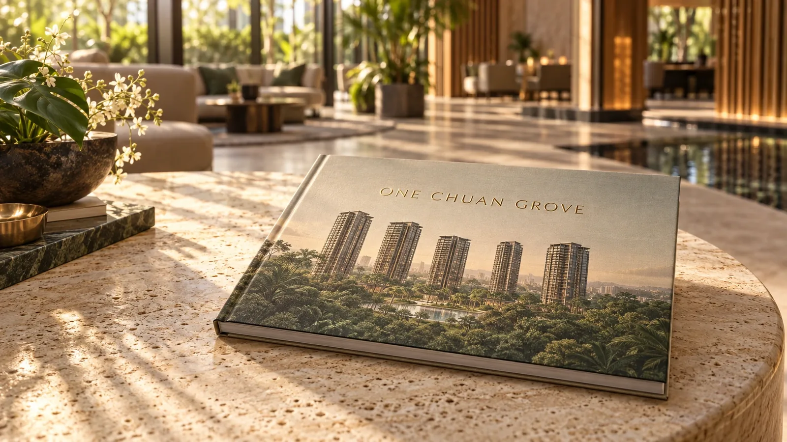 One Chuan Grove e-brochure preview: a hardcover brochure showing the towers above greenery, on a stone table in the clubhouse